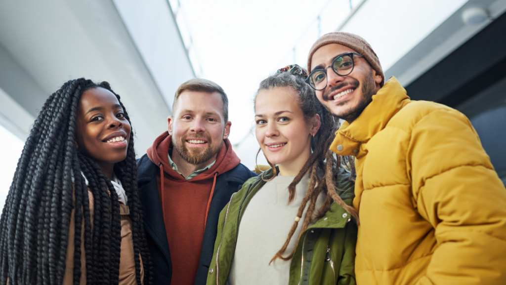 four people side by side smiling
